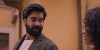 Movie still from “Love in the Villa” (2022), directed by Mark Steven Johnson – A man with a beard is looking at the camera; Close Up shot, Low angle