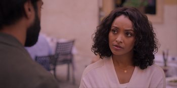 Movie still from “Love in the Villa” (2022), directed by Mark Steven Johnson – A person with curly hair; Close Up shot, Over the shoulder angle