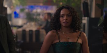 Movie still from “Love in the Villa” (2022), directed by Mark Steven Johnson – A woman in a green dress standing in front of a table; Close Up shot, Over the shoulder angle