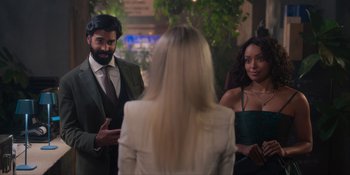 Movie still from “Love in the Villa” (2022), directed by Mark Steven Johnson – A group of people standing next to each other in a room; Medium shot, Over the shoulder angle