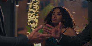 Movie still from “Love in the Villa” (2022), directed by Mark Steven Johnson – A woman in a green dress talking to a man in a black suit; Close Up shot, Over the shoulder angle