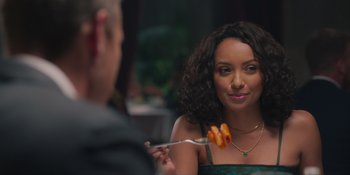 Movie still from “Love in the Villa” (2022), directed by Mark Steven Johnson – A woman holding a fork with a piece of food on top of it in front of a man; Close Up shot, Over the shoulder angle