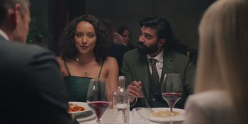 Movie still from “Love in the Villa” (2022), directed by Mark Steven Johnson – A man and a woman sitting at a dinner table; Medium shot, Over the shoulder angle