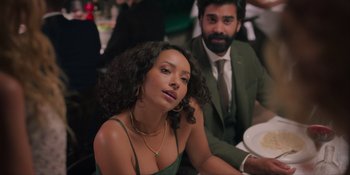 Movie still from “Love in the Villa” (2022), directed by Mark Steven Johnson – A man and a woman sitting at a dinner table; Medium shot, Over the shoulder angle