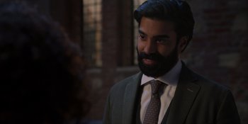 Movie still from “Love in the Villa” (2022), directed by Mark Steven Johnson – A man in a suit and a tie; Close Up shot, Over the shoulder angle