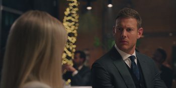 Movie still from “Love in the Villa” (2022), directed by Mark Steven Johnson – A man in a black suit and a woman in a black suit; Close Up shot, Over the shoulder angle
