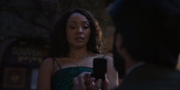 Movie still from “Love in the Villa” (2022), directed by Mark Steven Johnson – A woman in a green dress looking at a man in a black suit; Close Up shot, Over the shoulder angle