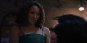 Movie still from “Love in the Villa” (2022), directed by Mark Steven Johnson – A woman in a green dress is looking at the camera; Close Up shot, Over the shoulder angle