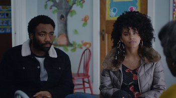 Movie still from “Atlanta” (2016), created by Donald Glover – A man and a woman sitting next to each other in a room; Medium shot, Over the shoulder angle