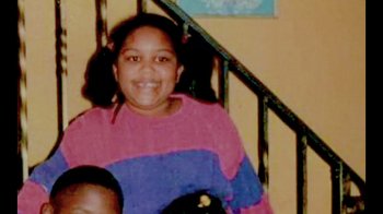 Movie still from “Love, Lizzo” (2022), directed by Doug Pray – A young girl sitting on top of a metal stair railing; Extreme Close Up shot, Overhead angle