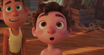 Movie still from “Luca” (2021), directed by Enrico Casarosa – A cartoon of a boy with brown hair looking surprised at the camera; Close Up shot, Over the shoulder angle