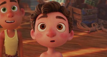 Movie still from “Luca” (2021), directed by Enrico Casarosa – A cartoon of a boy with brown hair and brown eyes; Close Up shot, High angle