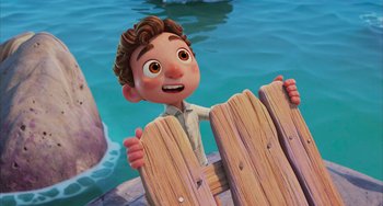 Movie still from “Luca” (2021), directed by Enrico Casarosa – A cartoon of a boy holding a fence; Medium shot, High angle