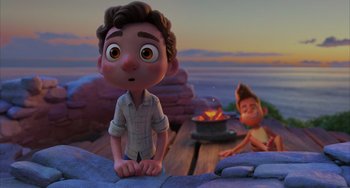 Movie still from “Luca” (2021), directed by Enrico Casarosa – A boy and a girl are sitting on a dock; Medium shot, Over the shoulder angle