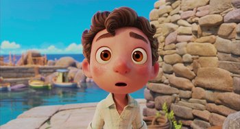 Movie still from “Luca” (2021), directed by Enrico Casarosa – An animated boy with brown hair and brown eyes looking surprised; Close Up shot, Over the shoulder angle