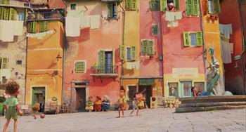 Movie still from “Luca” (2021), directed by Enrico Casarosa – A group of people standing in front of a pink building; Extreme Wide shot, Low angle
