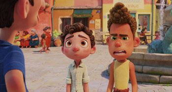 Movie still from “Luca” (2021), directed by Enrico Casarosa – Two animated characters standing next to each other on a street; Medium shot, Over the shoulder angle