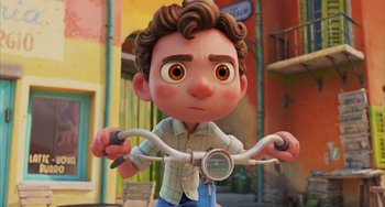 Movie still from “Luca” (2021), directed by Enrico Casarosa – A cartoon of a boy riding on a bike; Close Up shot, Low angle