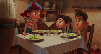 Movie still from “Luca” (2021), directed by Enrico Casarosa – A group of people sitting around a table with plates of food; Medium shot, High angle