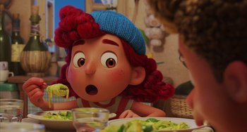 Movie still from “Luca” (2021), directed by Enrico Casarosa – A woman sitting in front of a plate of food; Close Up shot, Over the shoulder angle