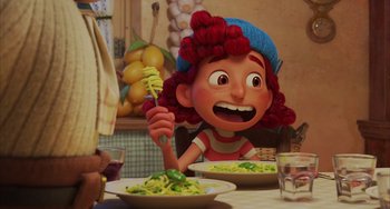 Movie still from “Luca” (2021), directed by Enrico Casarosa – A girl is holding a fork in front of a plate of food; Medium shot, Over the shoulder angle