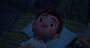 Movie still from “Luca” (2021), directed by Enrico Casarosa – A cartoon of a boy laying on a pillow; Medium shot, High angle