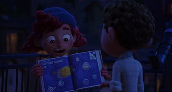 Movie still from “Luca” (2021), directed by Enrico Casarosa – A girl and a boy are looking at an open book; Medium shot, Over the shoulder angle