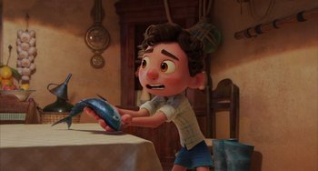 Movie still from “Luca” (2021), directed by Enrico Casarosa – An image of an animated character holding a fish; Medium shot, Over the shoulder angle