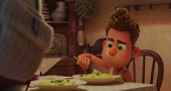 Movie still from “Luca” (2021), directed by Enrico Casarosa – A person sitting at a table with a plate of food; Close Up shot, Over the shoulder angle