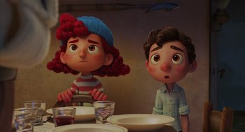 Movie still from “Luca” (2021), directed by Enrico Casarosa – A couple of people sitting at a dinner table; Medium shot, Over the shoulder angle