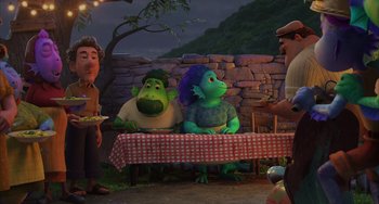 Movie still from “Luca” (2021), directed by Enrico Casarosa – A group of people sitting around a table; Wide shot, High angle