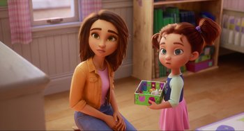 Movie still from “Luck” (2022), directed by Peggy Holmes – A woman sitting next to a little girl holding a box; Medium shot, Over the shoulder angle