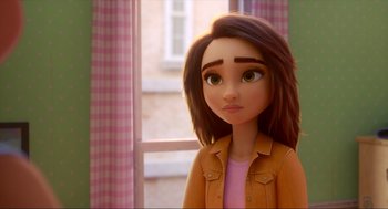 Movie still from “Luck” (2022), directed by Peggy Holmes – A girl with brown hair and a pink shirt is standing in front of a window; Close Up shot, Over the shoulder angle