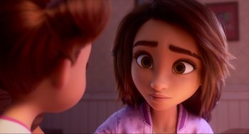 Movie still from “Luck” (2022), directed by Peggy Holmes – A girl with big brown eyes looking at another girl with short brown hair; Close Up shot, Over the shoulder angle