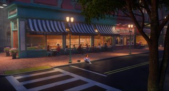 Movie still from “Luck” (2022), directed by Peggy Holmes – A woman sitting on the side of the street; Extreme Wide shot, High angle