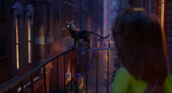 Movie still from “Luck” (2022), directed by Peggy Holmes – A cat standing on a railing in the middle of a street; Wide shot, Over the shoulder angle
