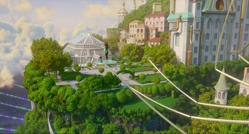 Movie still from “Luck” (2022), directed by Peggy Holmes – An artistic rendering of a park with a lot of trees and buildings; Extreme Wide shot, High angle