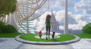 Movie still from “Luck” (2022), directed by Peggy Holmes – A woman and two small cats walking on a green field; Wide shot, High angle