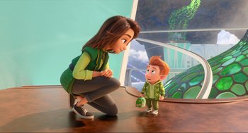 Movie still from “Luck” (2022), directed by Peggy Holmes – A woman kneeling down next to a small boy; Medium shot, Over the shoulder angle