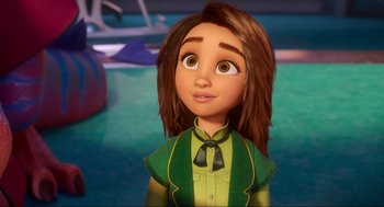 Movie still from “Luck” (2022), directed by Peggy Holmes – A girl with brown hair wearing a green shirt and a bow tie; Close Up shot, Over the shoulder angle