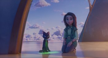 Movie still from “Luck” (2022), directed by Peggy Holmes – A woman sitting on the ground next to a cat; Wide shot, High angle