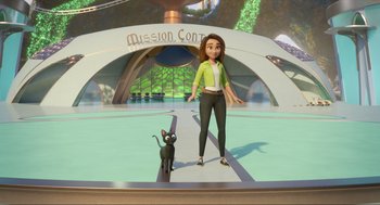 Movie still from “Luck” (2022), directed by Peggy Holmes – A woman standing next to a black cat on a platform; Wide shot, High angle