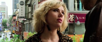 Movie still from “Lucy” (2014), directed by Luc Besson – A person wearing a leopard print jacket; Close Up shot, Low angle