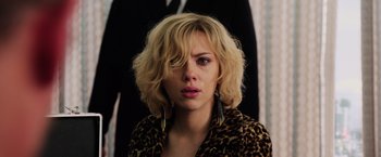 Movie still from “Lucy” (2014), directed by Luc Besson – A person wearing a leopard print jacket; Close Up shot, Low angle