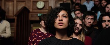Movie still from “Lucy” (2014), directed by Luc Besson – A group of people standing in front of a clock; Close Up shot, High angle