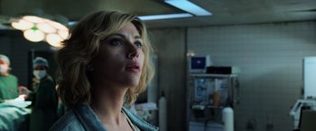 Movie still from “Lucy” (2014), directed by Luc Besson – A person in a room near a window; Close Up shot, Low angle