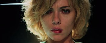 Movie still from “Lucy” (2014), directed by Luc Besson – A woman's face with blood all over it; Close Up shot, Low angle