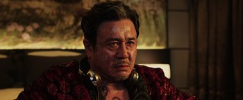 Movie still from “Lucy” (2014), directed by Luc Besson – A person wearing a red jacket; Close Up shot, Low angle