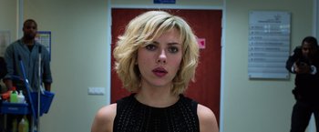 Movie still from “Lucy” (2014), directed by Luc Besson – A person with short blonde hair; Close Up shot, Low angle