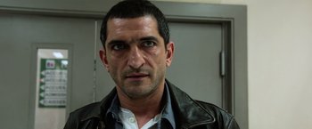 Movie still from “Lucy” (2014), directed by Luc Besson – A person wearing a leather jacket; Close Up shot, Low angle